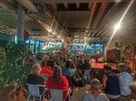 Een vol Eemhuis met mensen die naar een live muziekoptreden kijken.